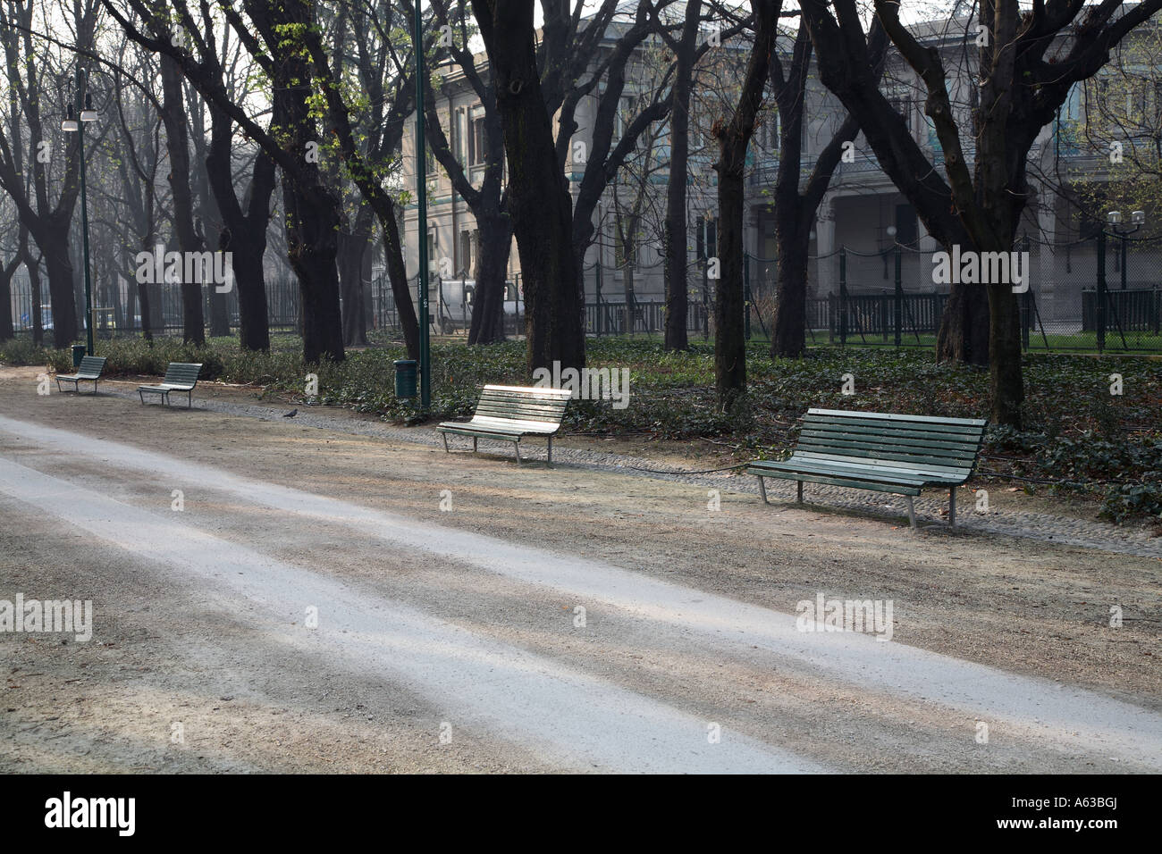 series of benches in a city park Stock Photo - Alamy