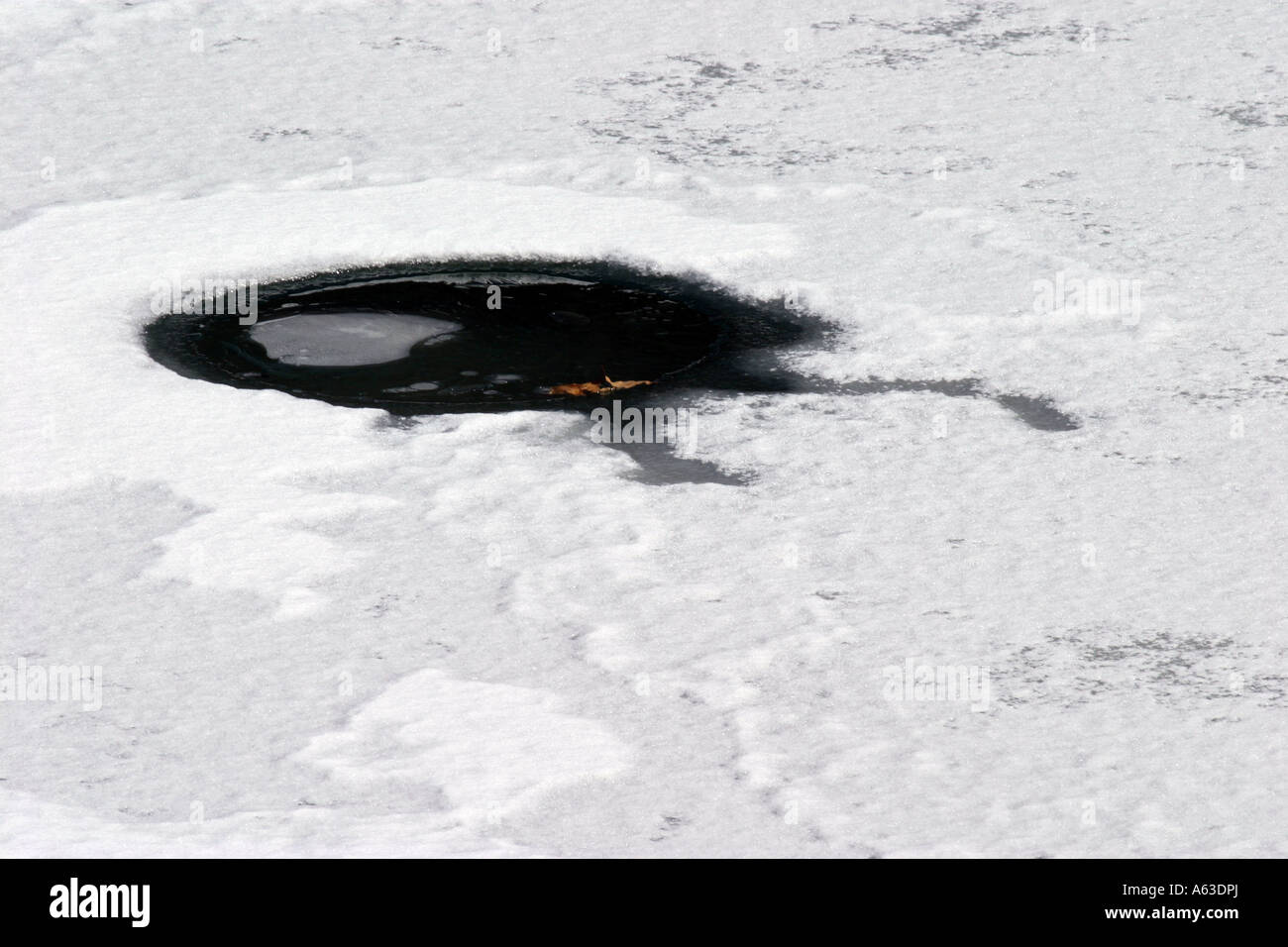 Hole in ice at Raccoon Creek State Park Pennsylvania Stock Photo