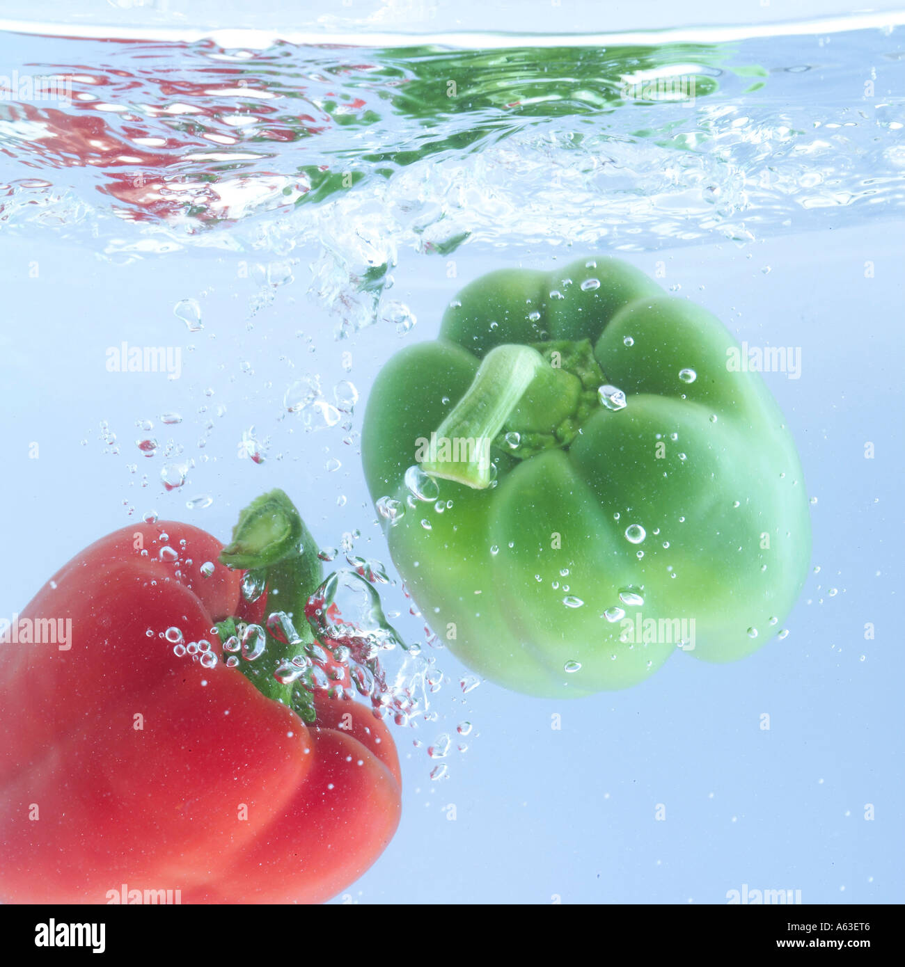Close-up of red and green bell peppers in water Stock Photo