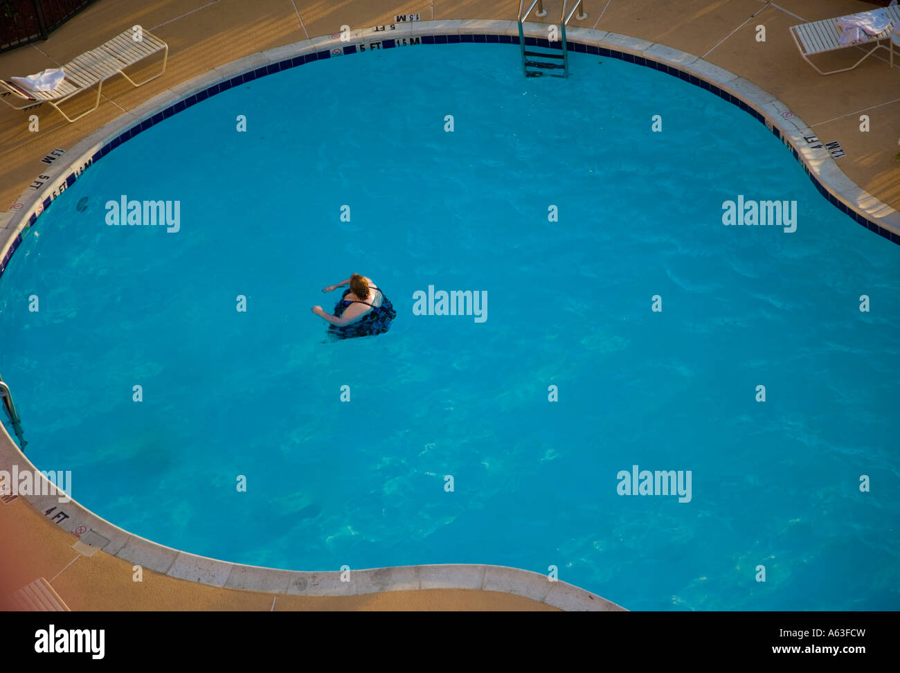Overweight woman in a swimming pool Stock Photo
