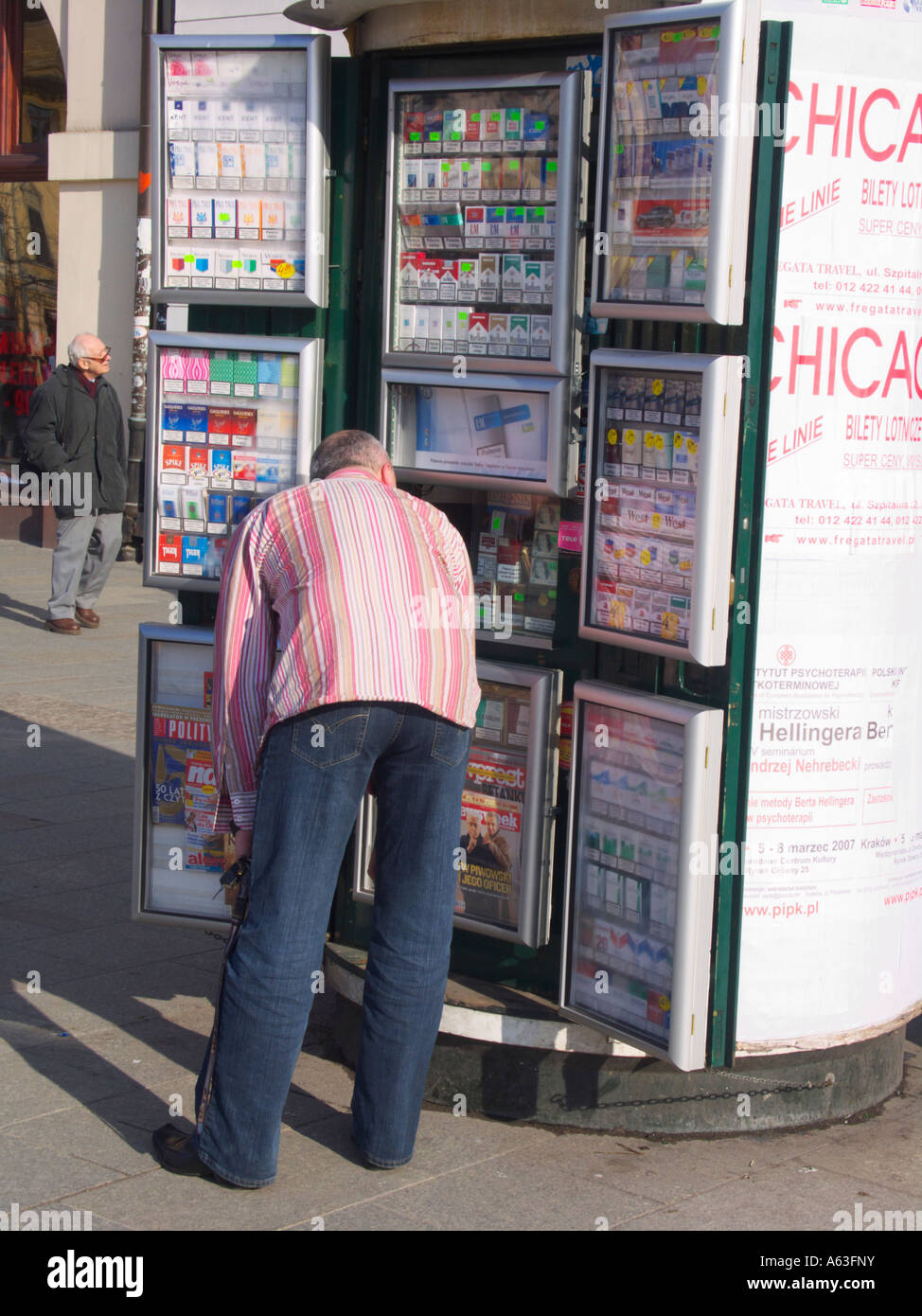 Man buying cigarettes from kiosk in Rynek Glowny, Krakow, Poland Stock  Photo