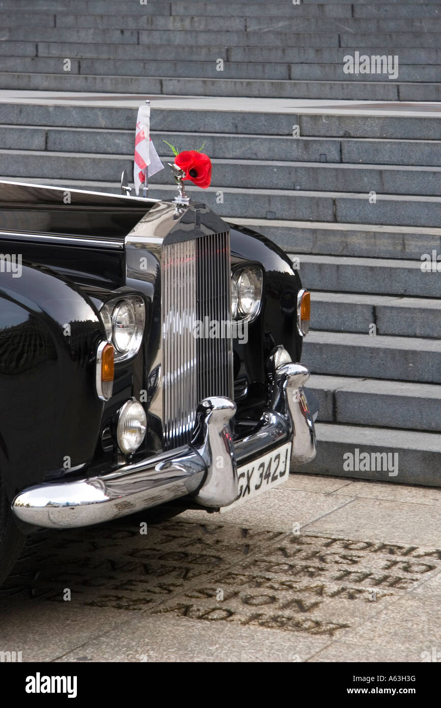 Red poppies for Rememberance day on the radiator grill of a black Rolls