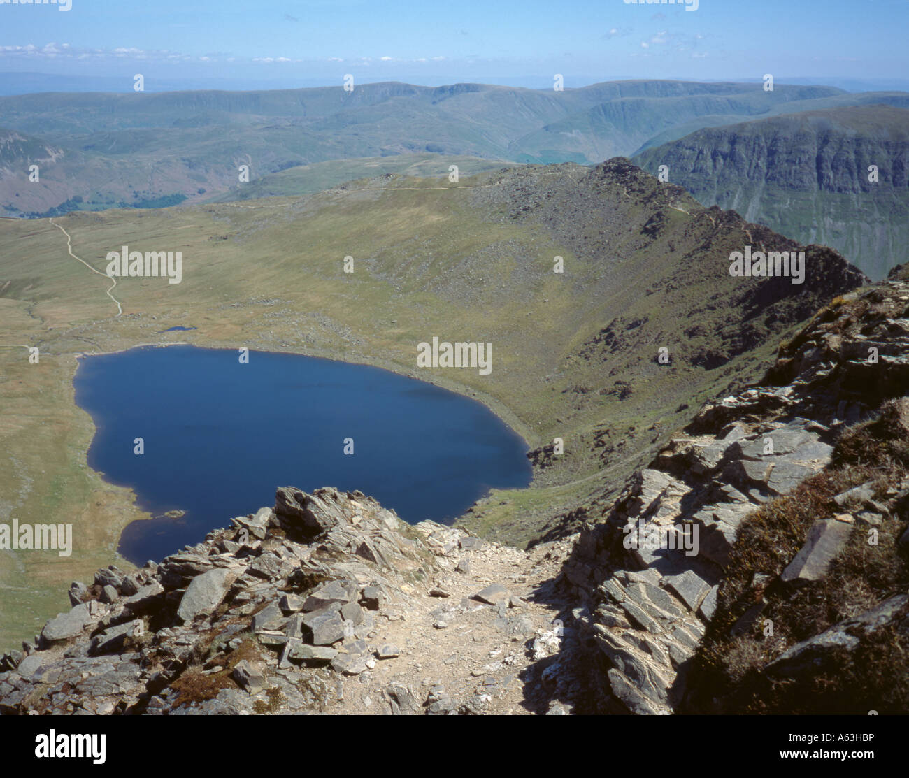 Red Tarn seen from Swirral Edge, Helvellyn, with Striding Edge beyond on the right, Lake District, Cumbria, England, UK. Stock Photo