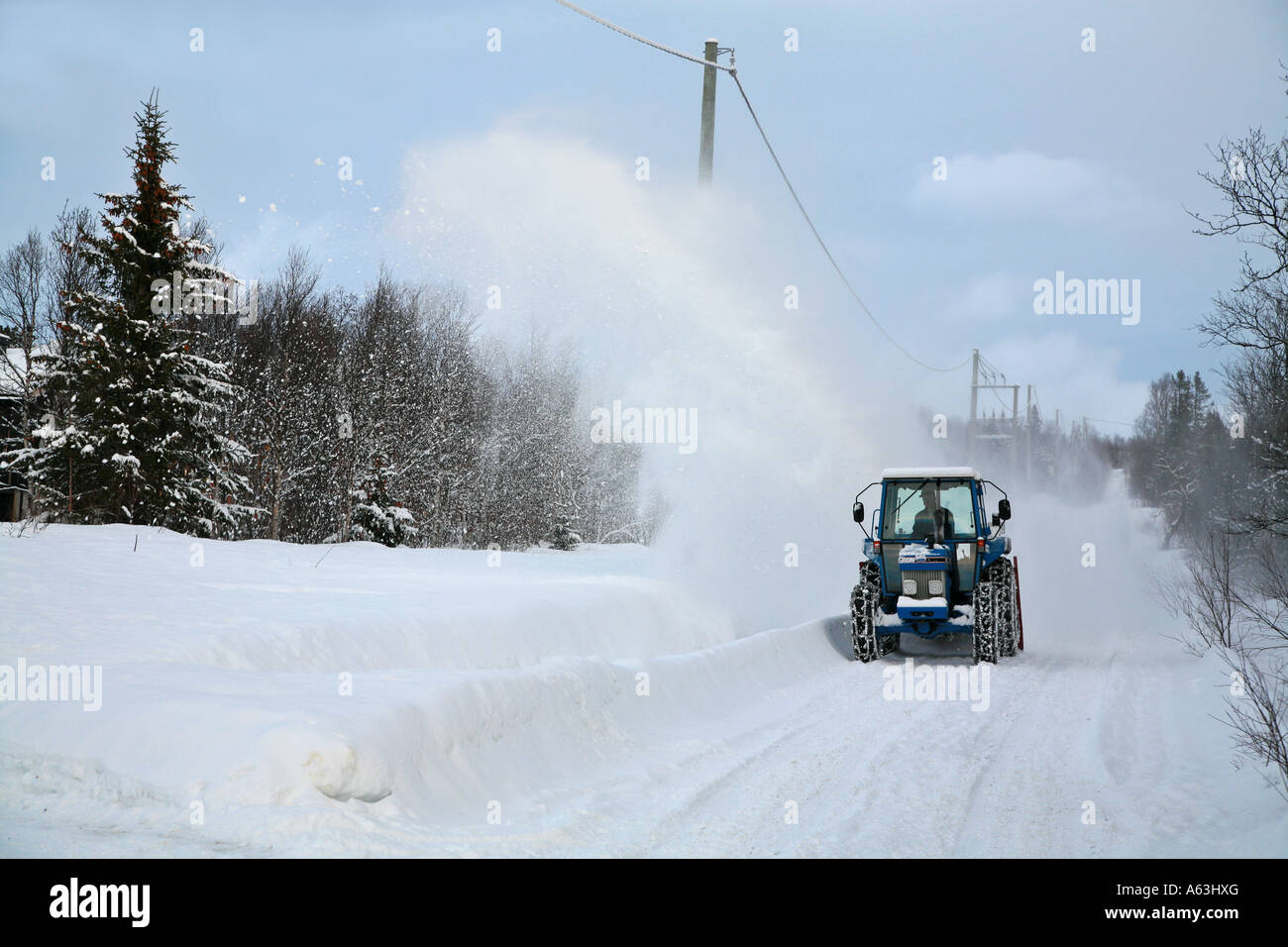 Snow blowing the road in Norway Stock Photo