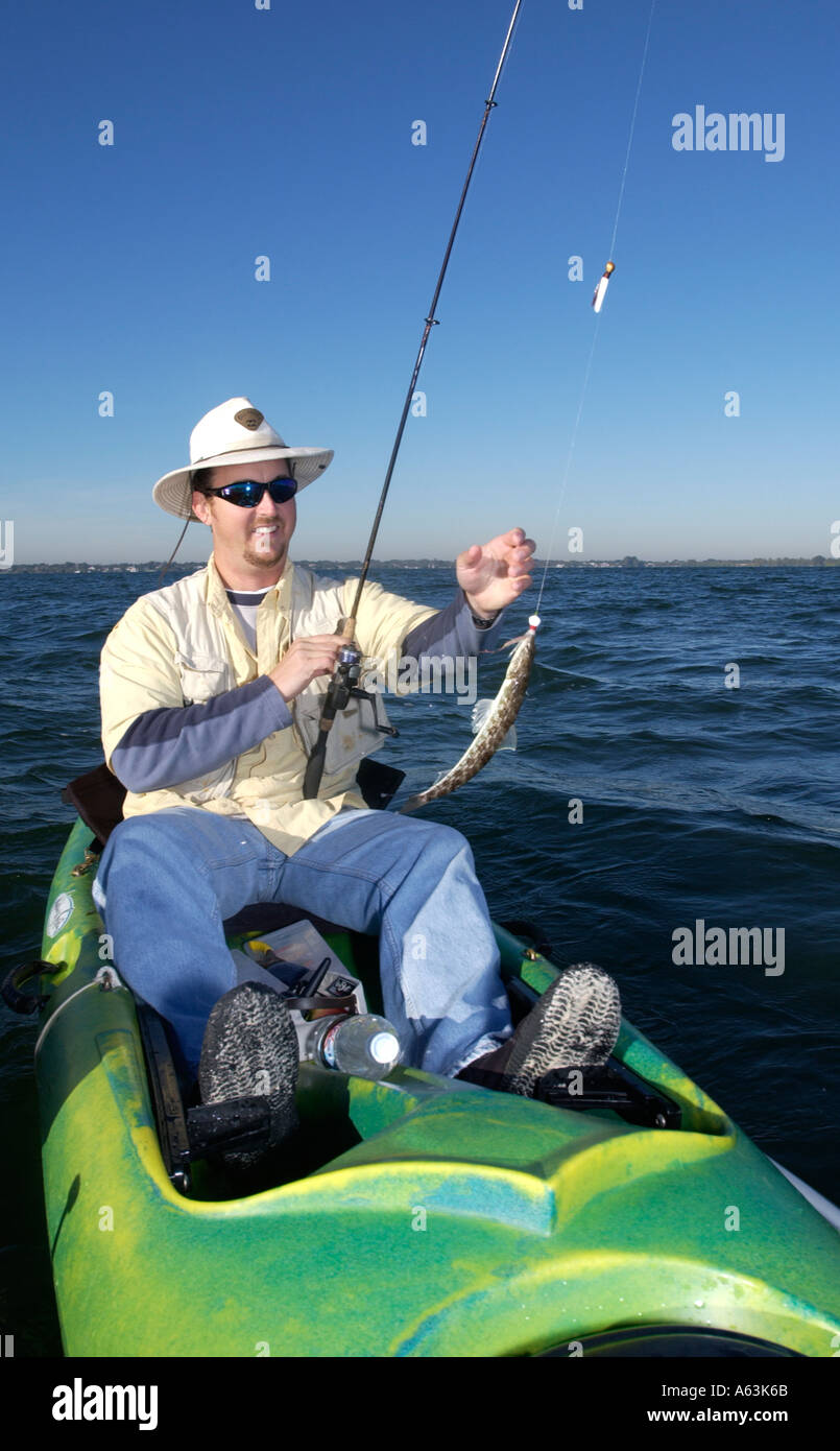 Man fishing from kayak caught Lizard fish Intracoastal waterway Indian