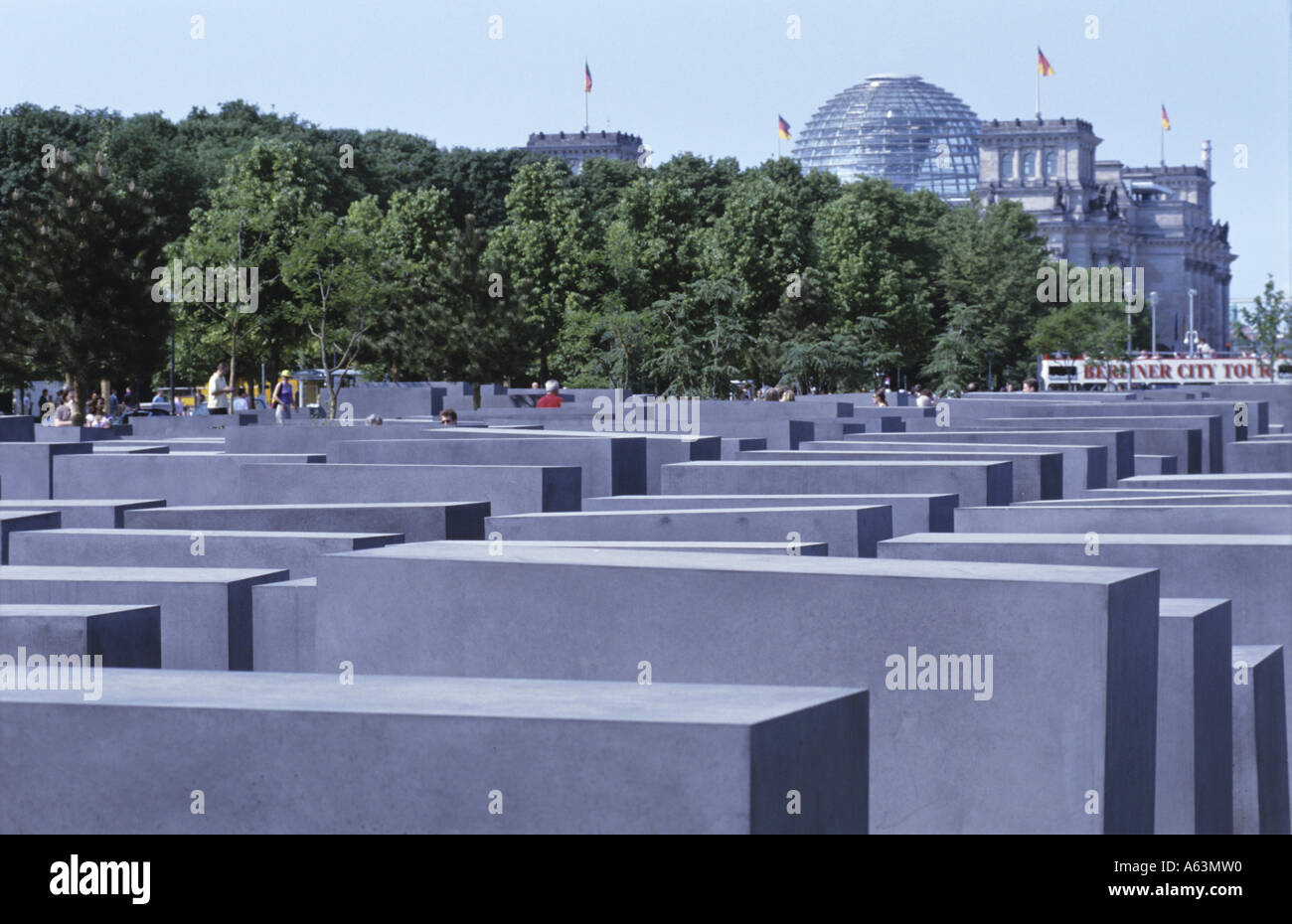 Concrete steles at memorial with buildings in background, Monument To The Murdered Jews Of Europe, Berlin, Germany Stock Photo