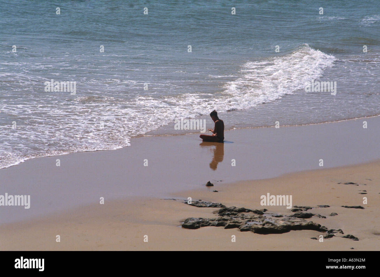 woman meditating at beach near village of conil de la frontera coast costa de la luz region of andalucia province of cadiz spain Stock Photo