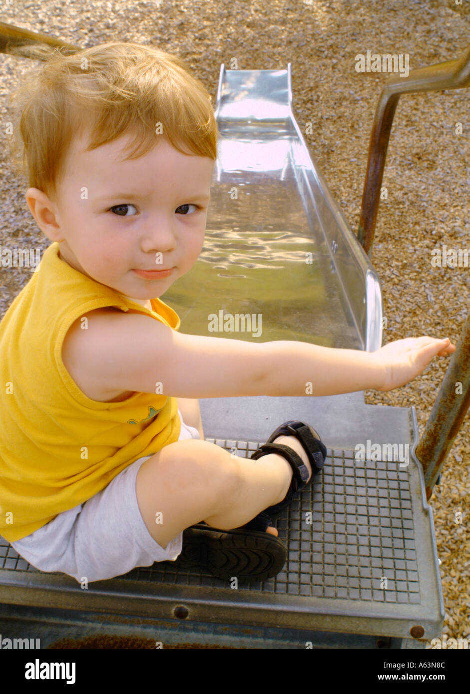 Toddler ready to go down slide at public park boys children parks rides