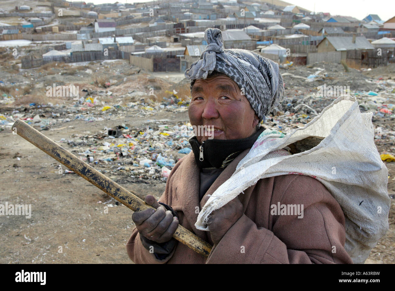 Mongolia, Ulan Bator - Beggar collects plastic bottles on a garbage dump Stock Photo