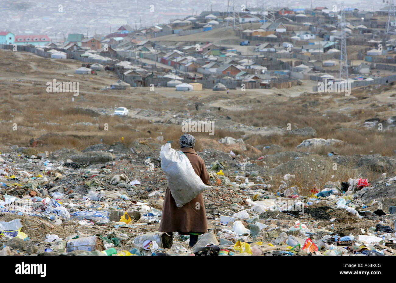 Mongolia, Ulan Bator - Beggar collects plastic bottles on a garbage dump Stock Photo