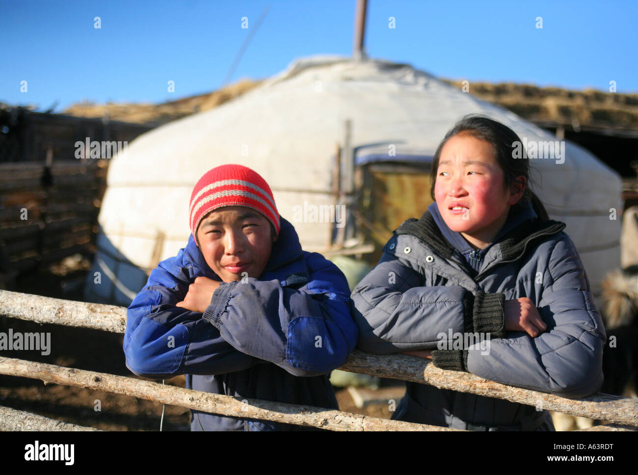Mongolia - nomad children in front of a traditional ger in the stepps Stock Photo