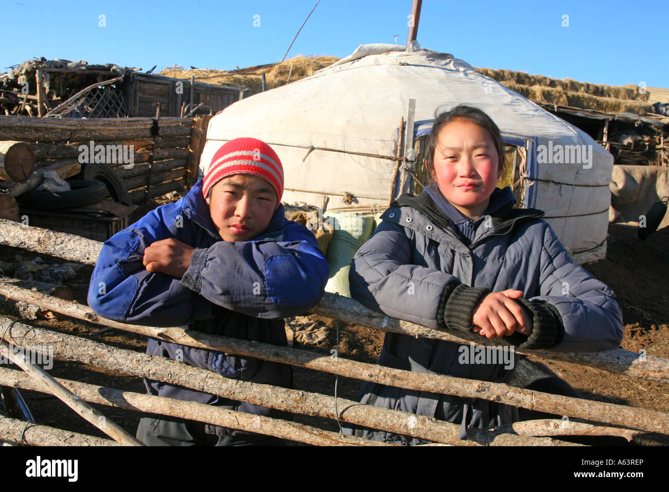 Mongolia - nomad children in front of a traditional ger in the stepps ...