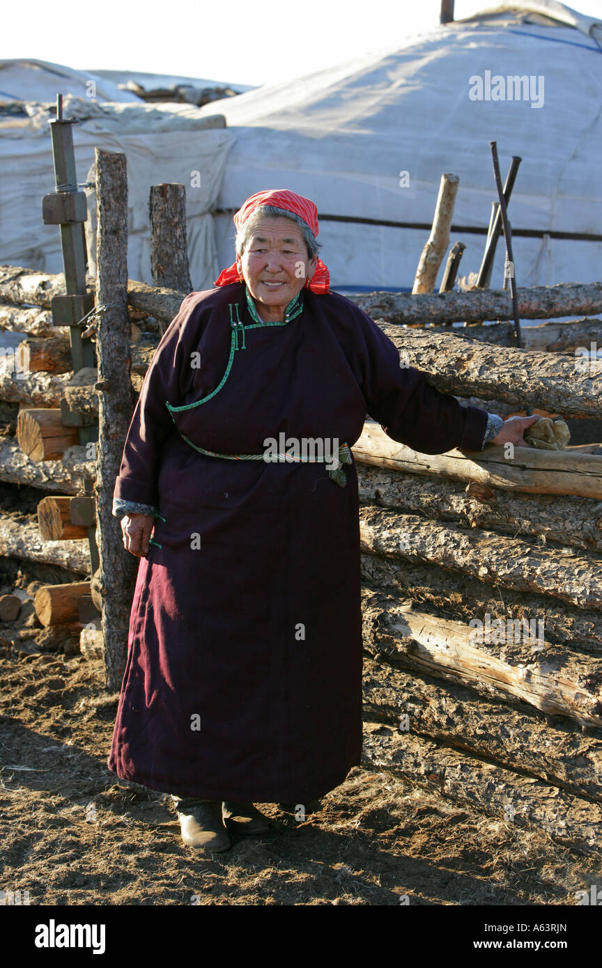Mongolia - nomad woman in front of a traditional ger in the stepps ...