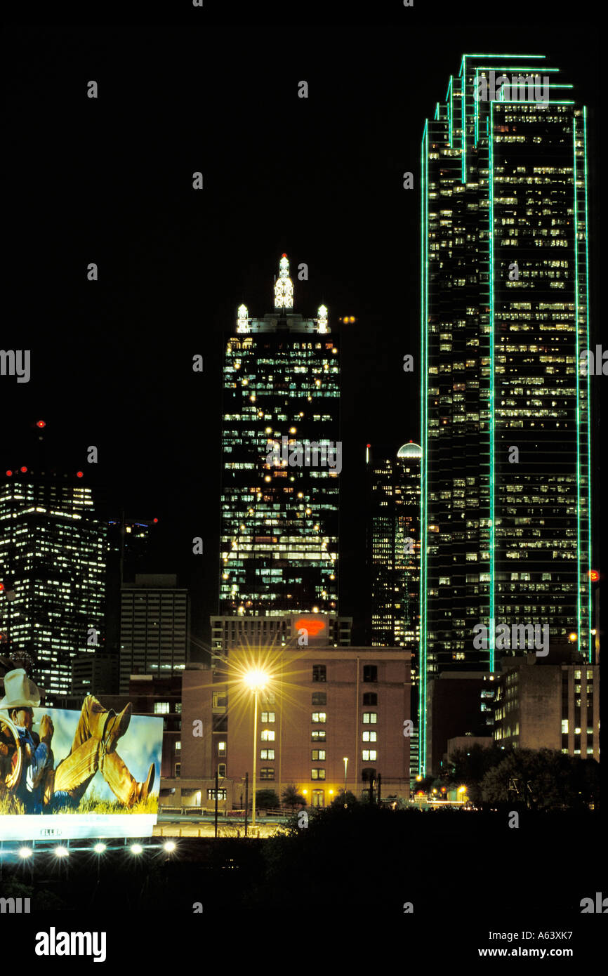 Dallas Texas Skyline At Night Billboard With Marlboro Man Cowboy In Foreground Stock Photo