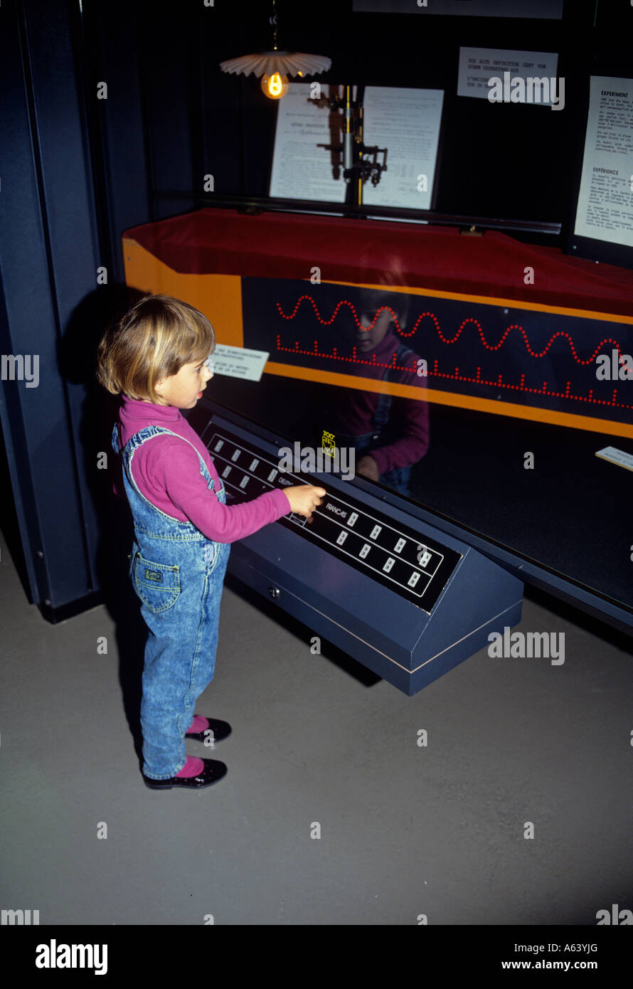 little girl controlling alternating current or audio frequency swiss science center museum of technorama winterthur switzerland Stock Photo