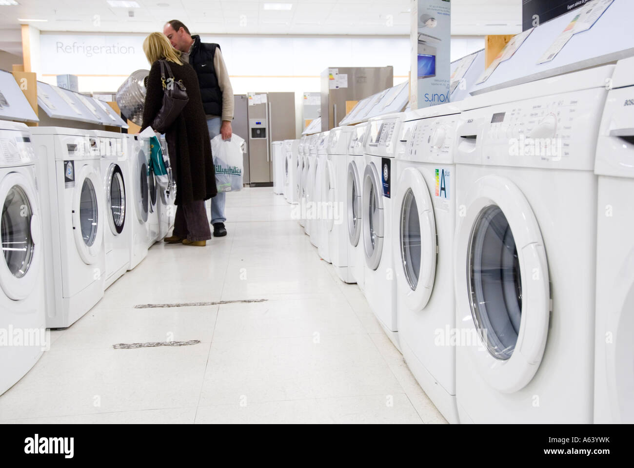 Couple looking at new washing machines in John Lewis, London, UK Stock Photo