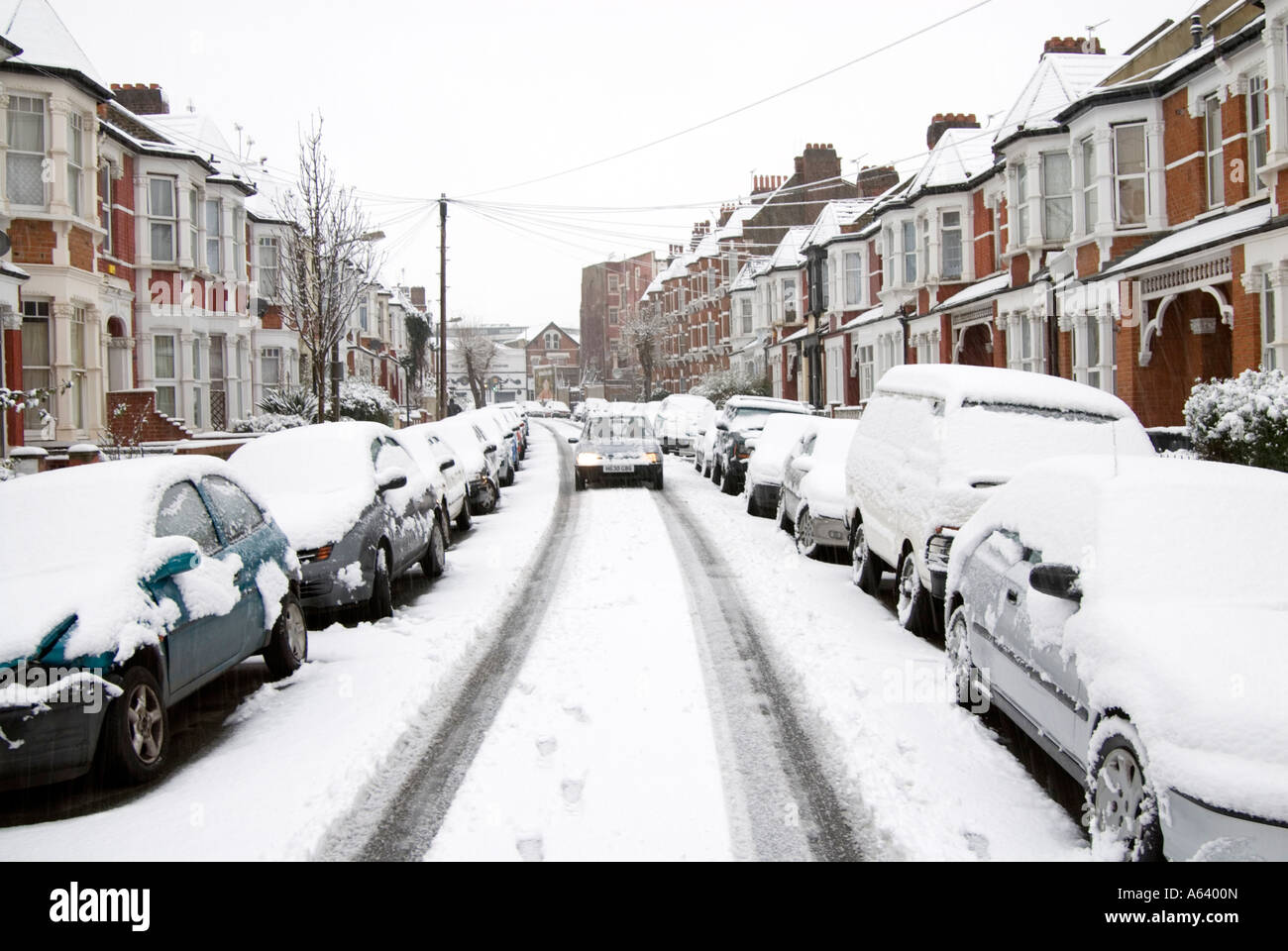 Snow covered cars in residential street, London England UK Stock Photo
