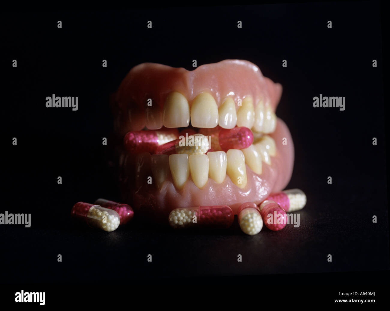 teeth stuffing capsules symbolism for drug obsession Stock Photo