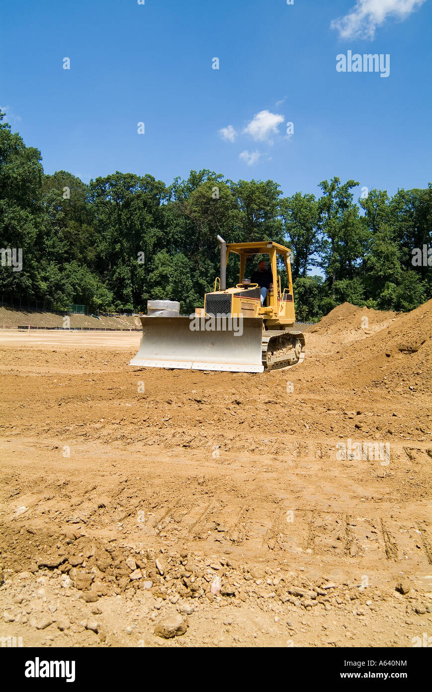 Bulldozer Pushing Dirt At Construction Site Stock Photo