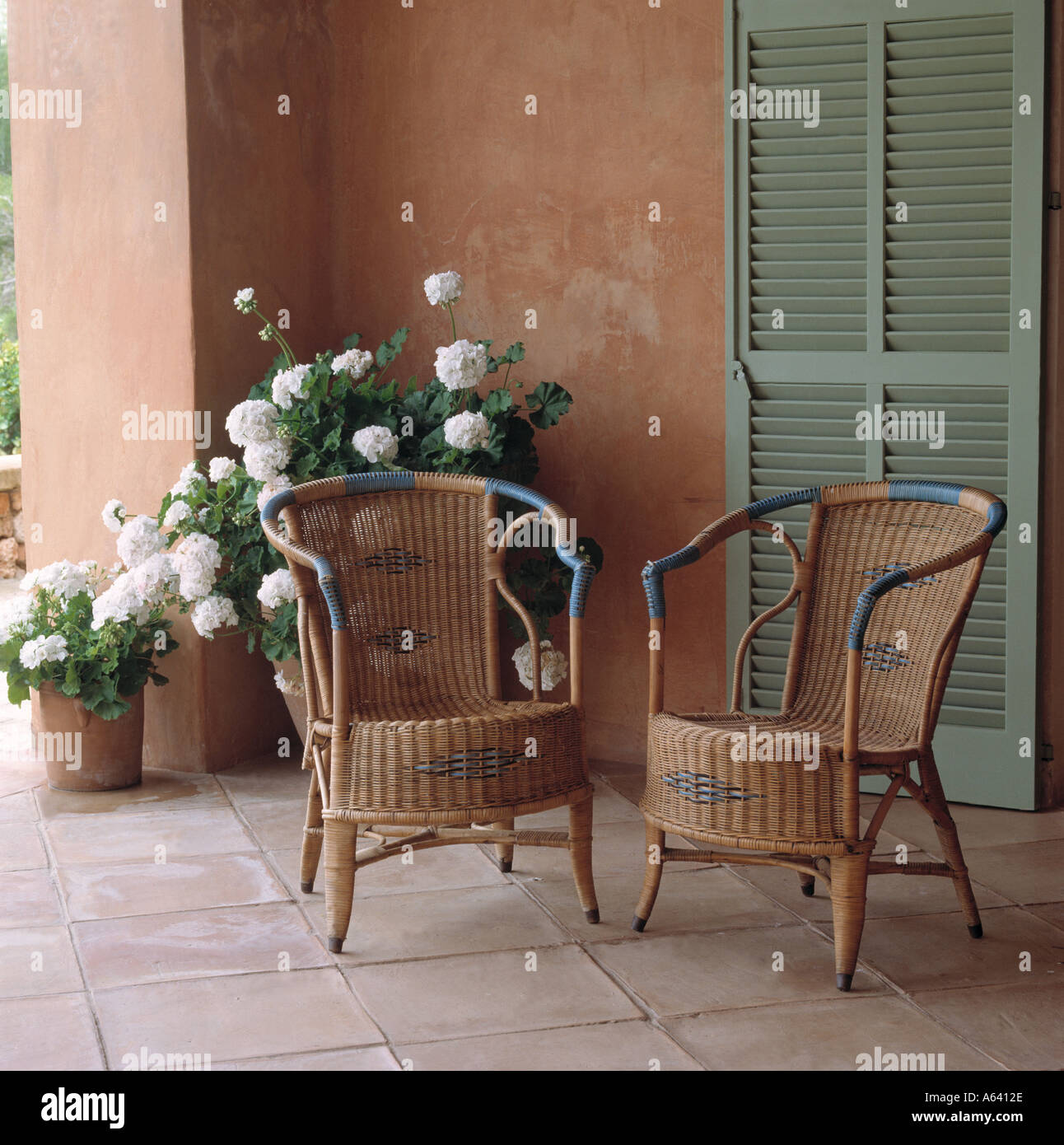 two wicker chairs on a patio Stock Photo - Alamy