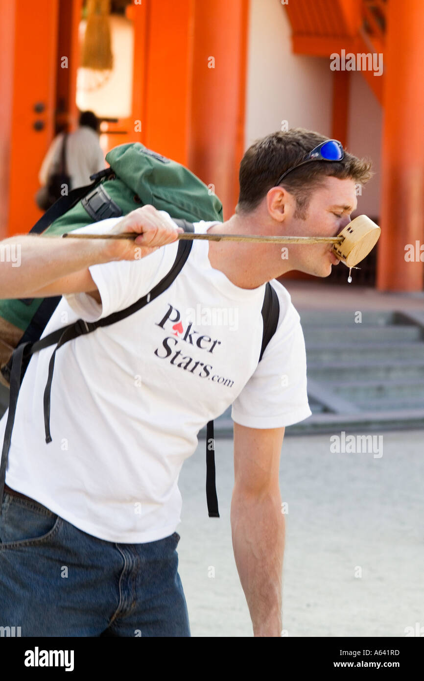 Japan, Kyoto, Man drinking from long handled cup Stock Photo