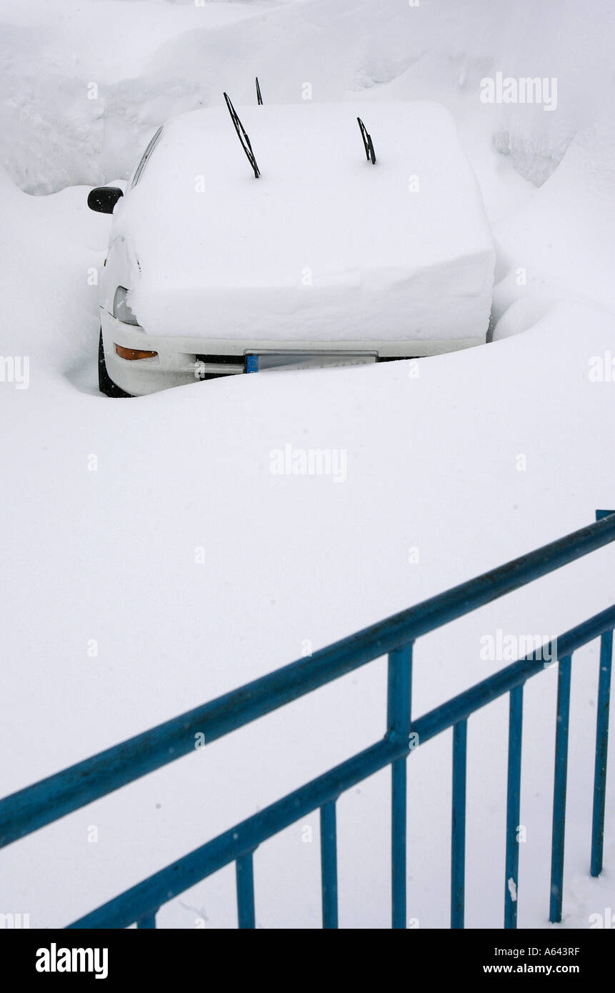 Snow covered car on a snowed in parking lot Stock Photo Alamy