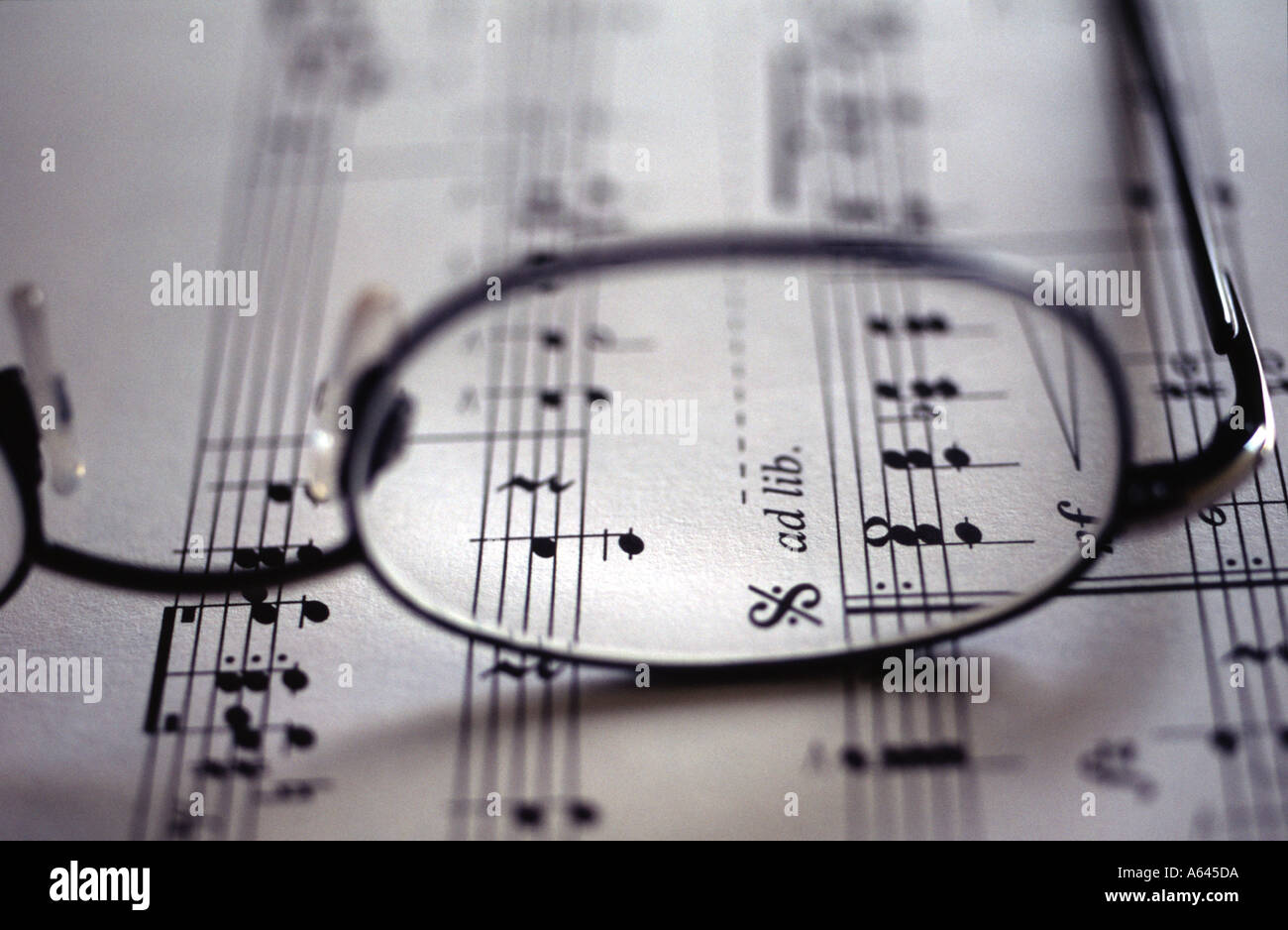 Spectacles resting on a piece of manuscript Stock Photo