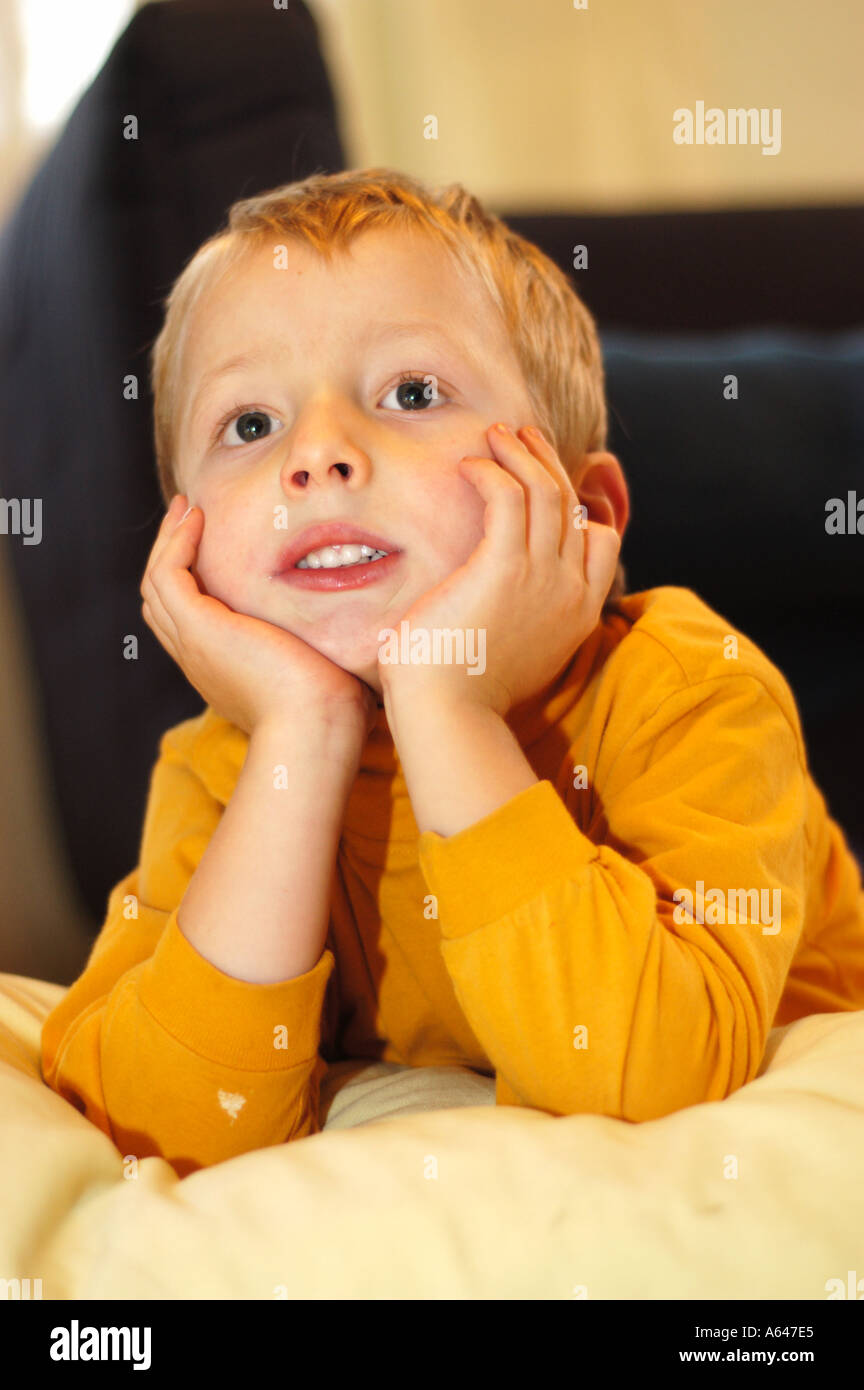 Five year old boy watching tv Stock Photo Alamy