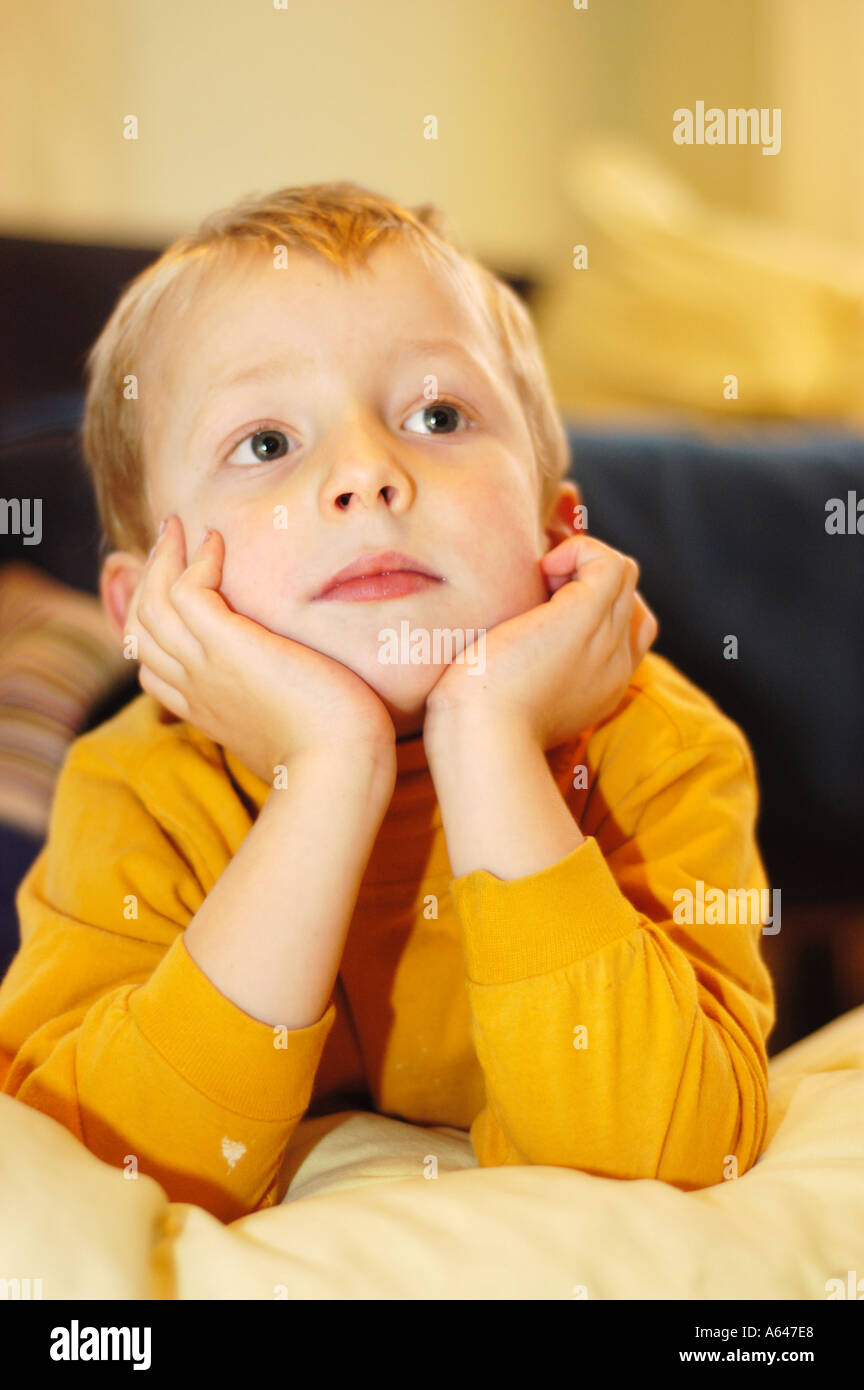 Five year old boy watching tv Stock Photo Alamy