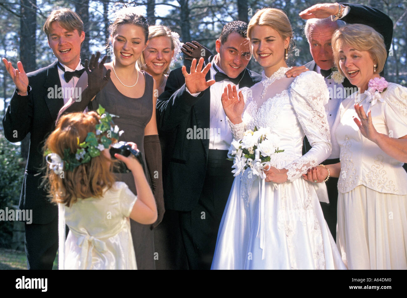 Flower girl photographing wedding party Stock Photo