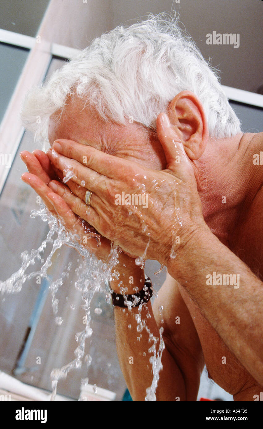 elderly man washing his face Stock Photo Alamy