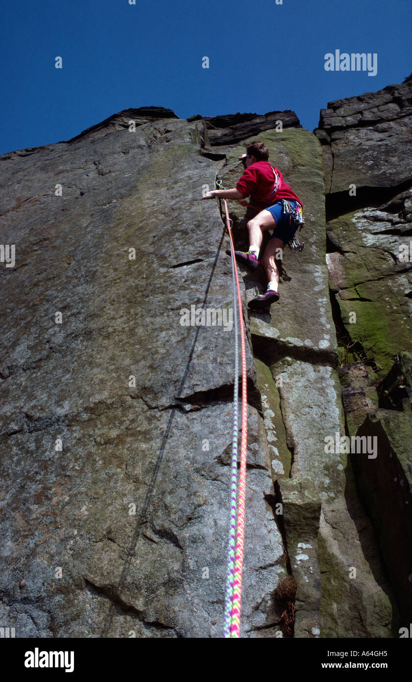 Rock climbing on Curbar Edge Peak District National Park Derbyshire Stock Photo