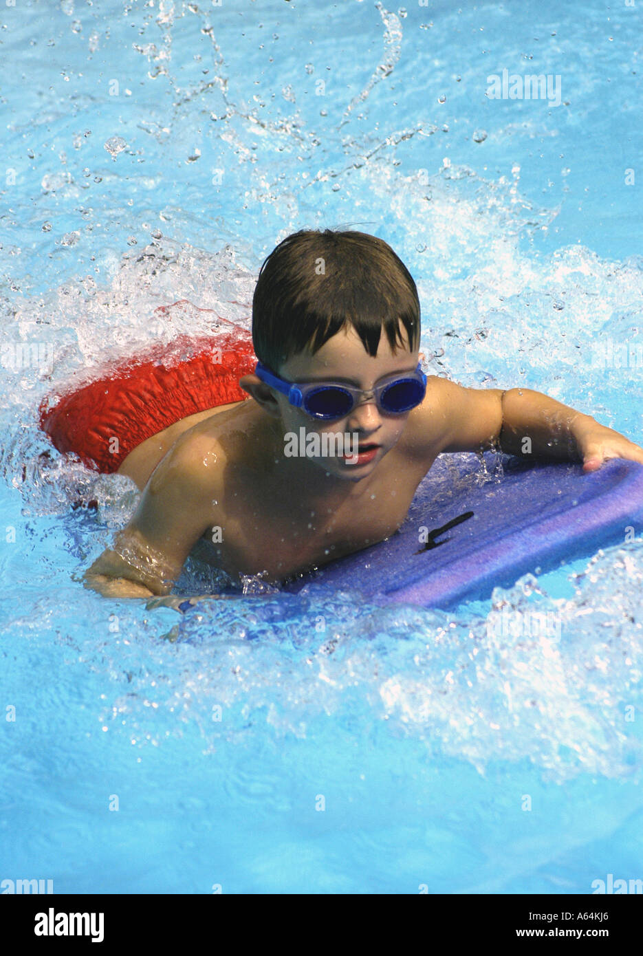 Boy playing swimming pool raft Stock Photo - Alamy