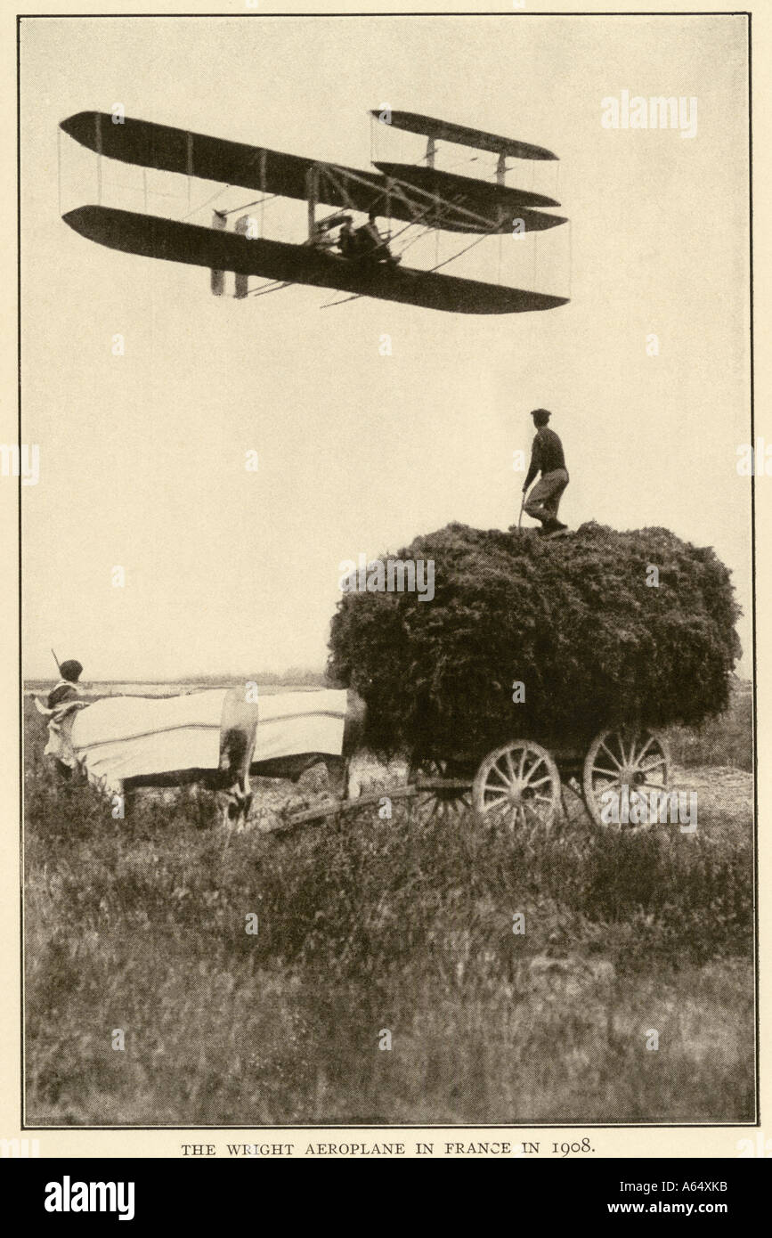 Wilbur Wright and a pupil in an early airplane flying over an oxdrawn hay wagon in France 1908. Albertype reproduction of a photograph Stock Photo