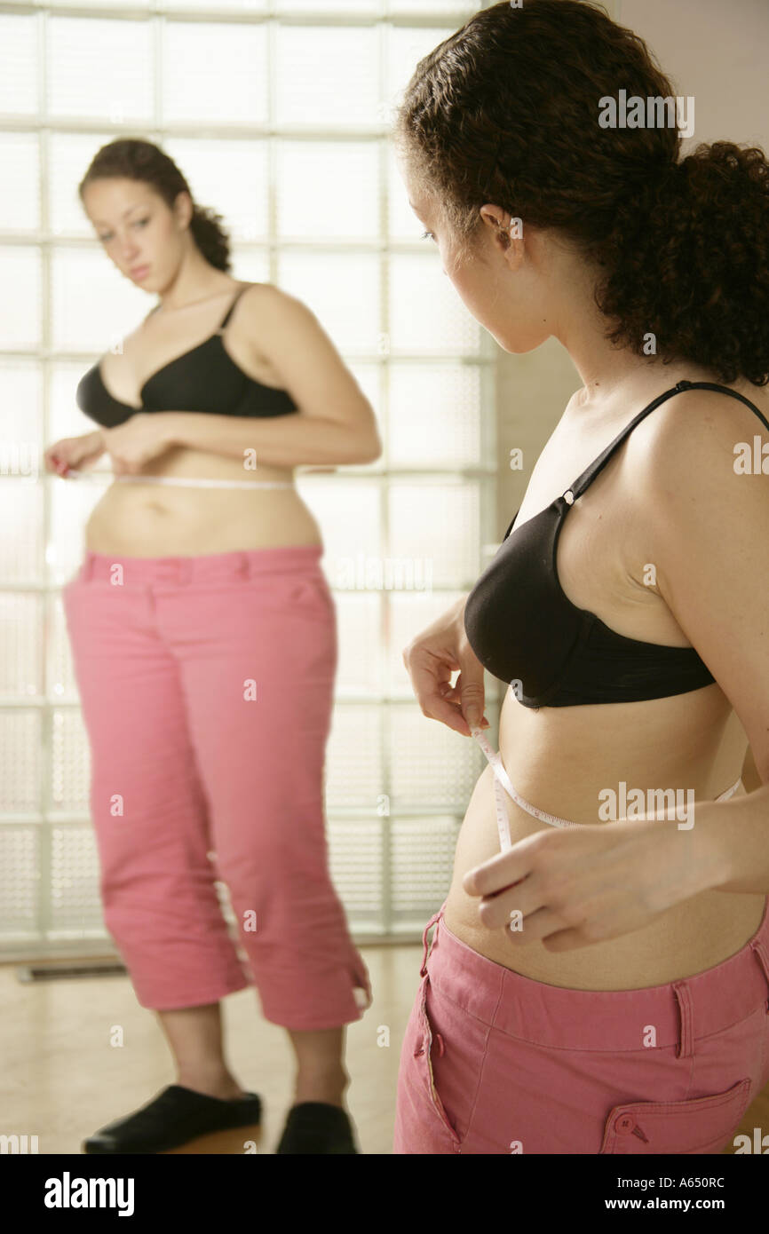 Young woman  with Body Dysmorphic Disorder, seeing herself as larger then she really is. Stock Photo