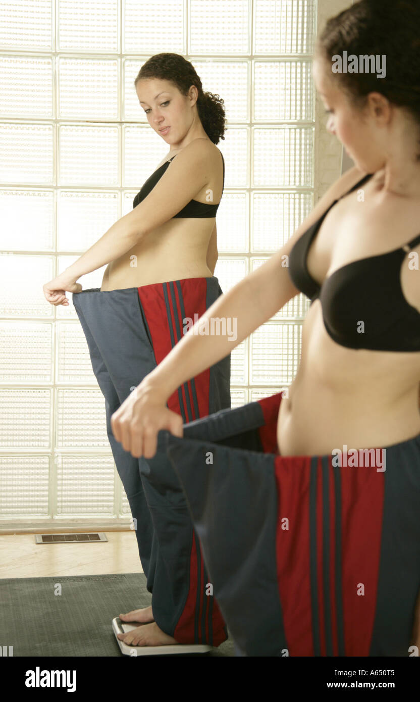 Young woman with large pants. Her diet has been successful! Stock Photo
