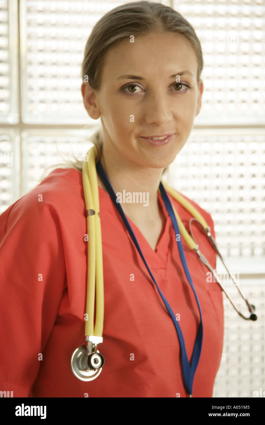 Nurse or doctor wearing red scrubs and a yellow stethoscope Stock Photo