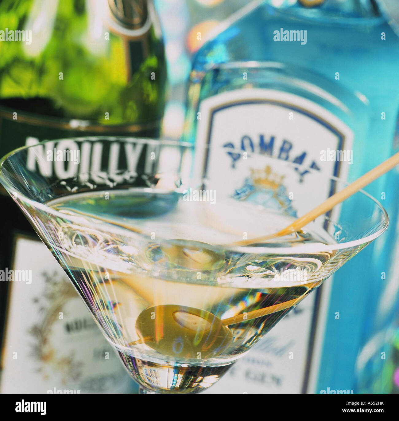 A classic Martini cocktail made with Bombay Sapphire gin and Noilly Prat, and a stuffed olive on a cocktail stick. Stock Photo