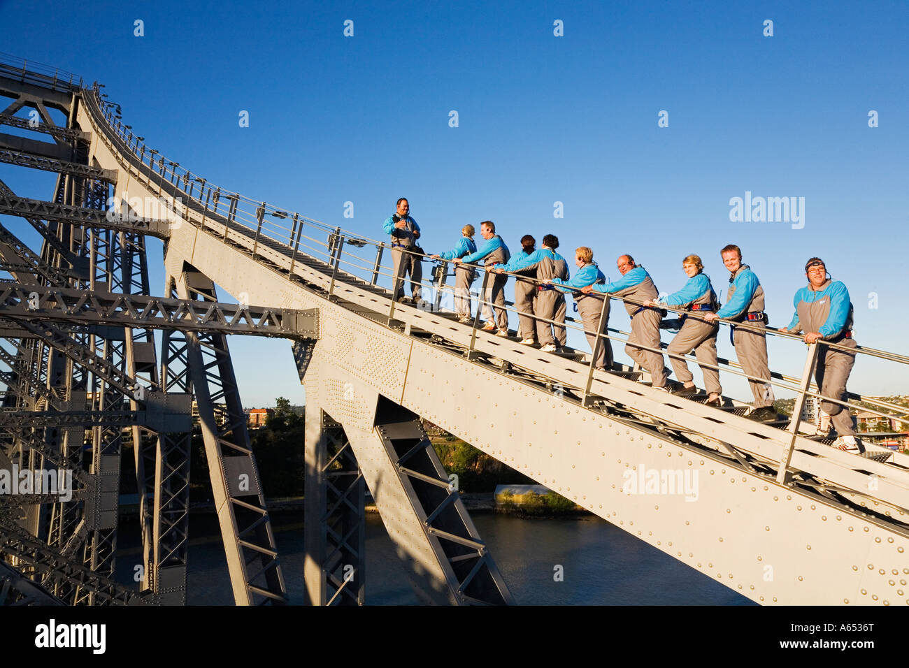 A group of climbers make their way up the steel girders of Brisbane's Story Bridge Stock Photo