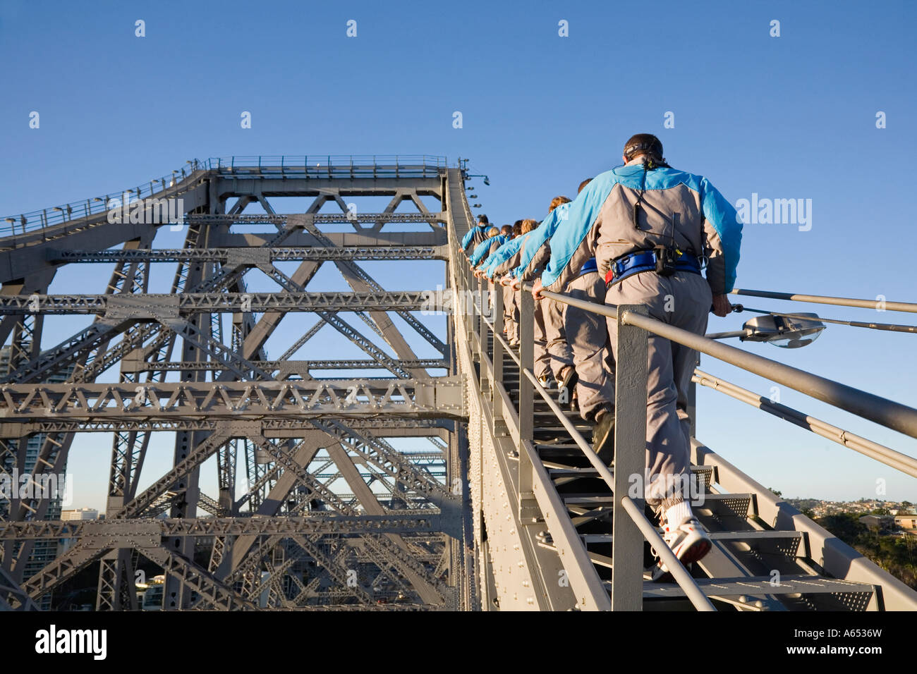 A group of climbers make their way up the steel girders of Brisbane's Story Bridge Stock Photo