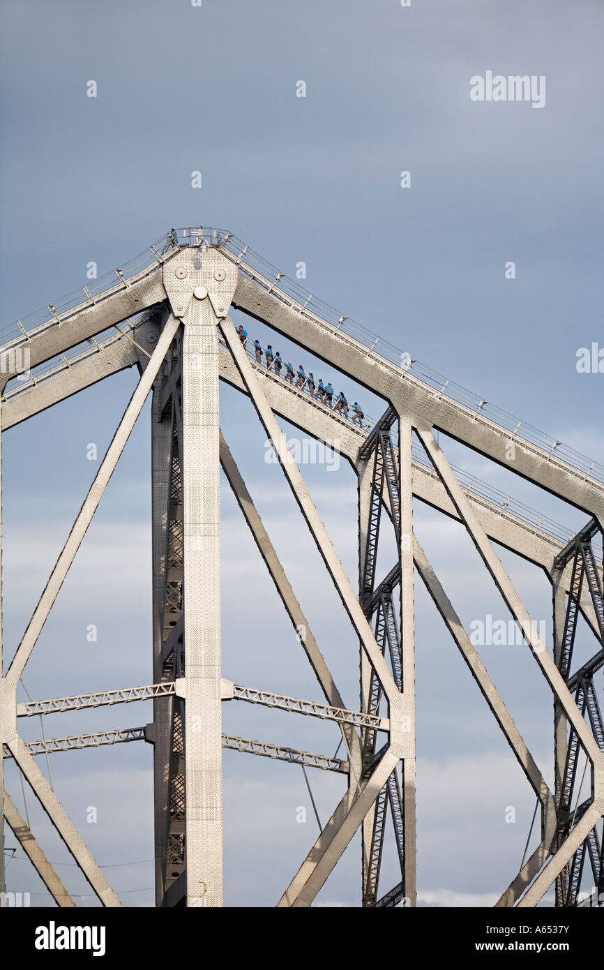 Climbers traverse the steel girders of the Story Bridge in Brisbane Stock Photo