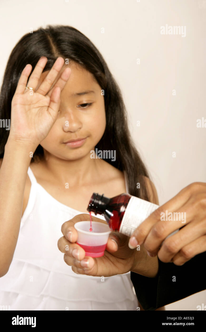 Mom Gives Her Sick Daughter Cough Syrup To Help Her Feel Better Stock