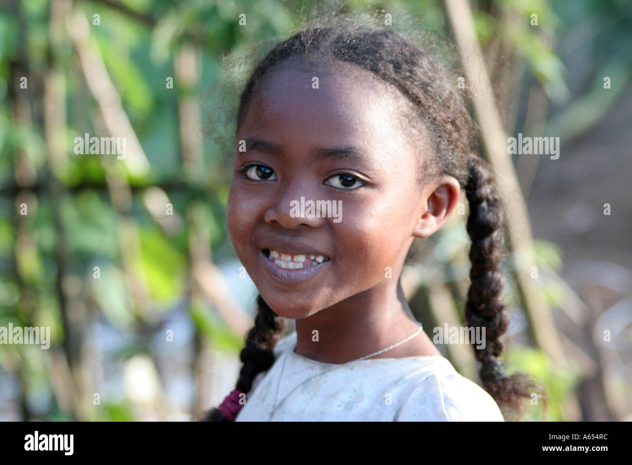 Young girl with long black braided hair, Manakara, Madagascar Stock Photo