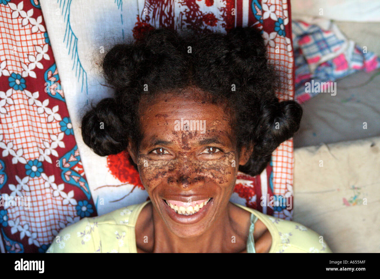 Woman wearing a mud mask in Ifaty, north of Toliara, ( Tulear ), Madagascar Stock Photo