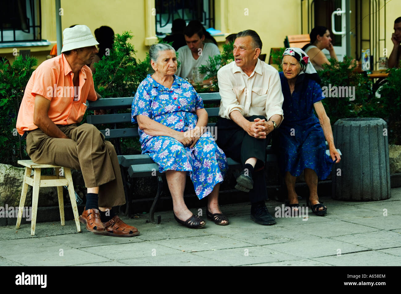 Old Locals Talking on Bench Stock Photo - Alamy