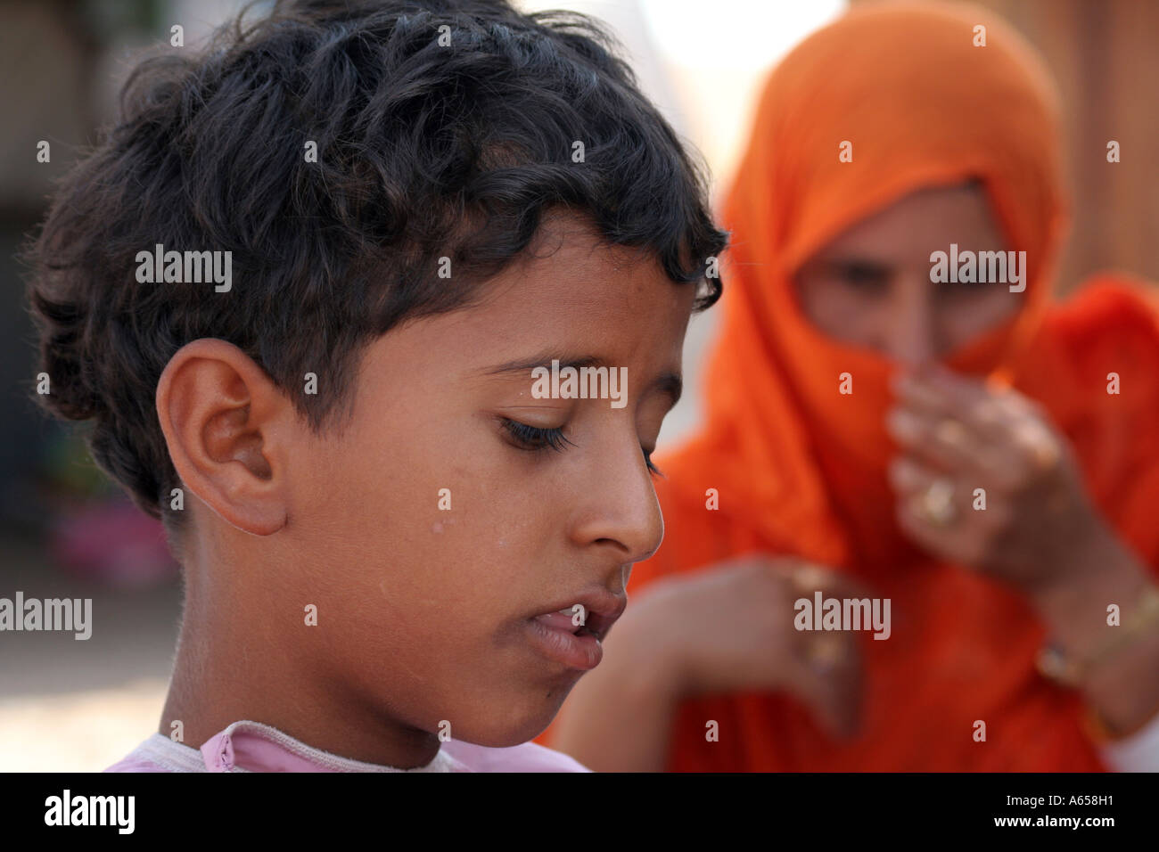 Wahiba Sands, Sharqiya, Oman, Bedouin mother behind young son Stock Photo
