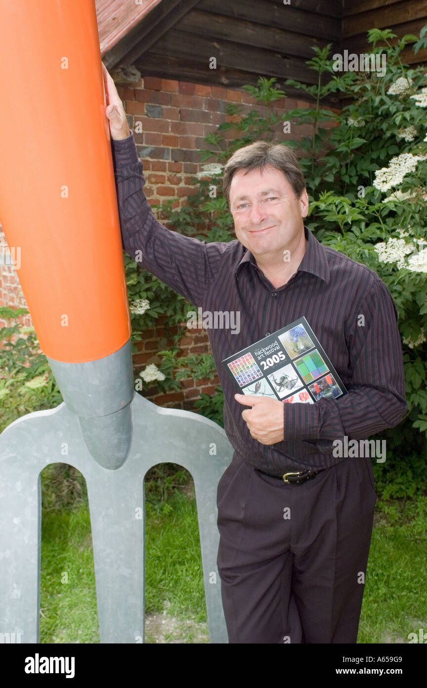 Alan Titchmarsh stands next to a giant garden fork Stock Photo