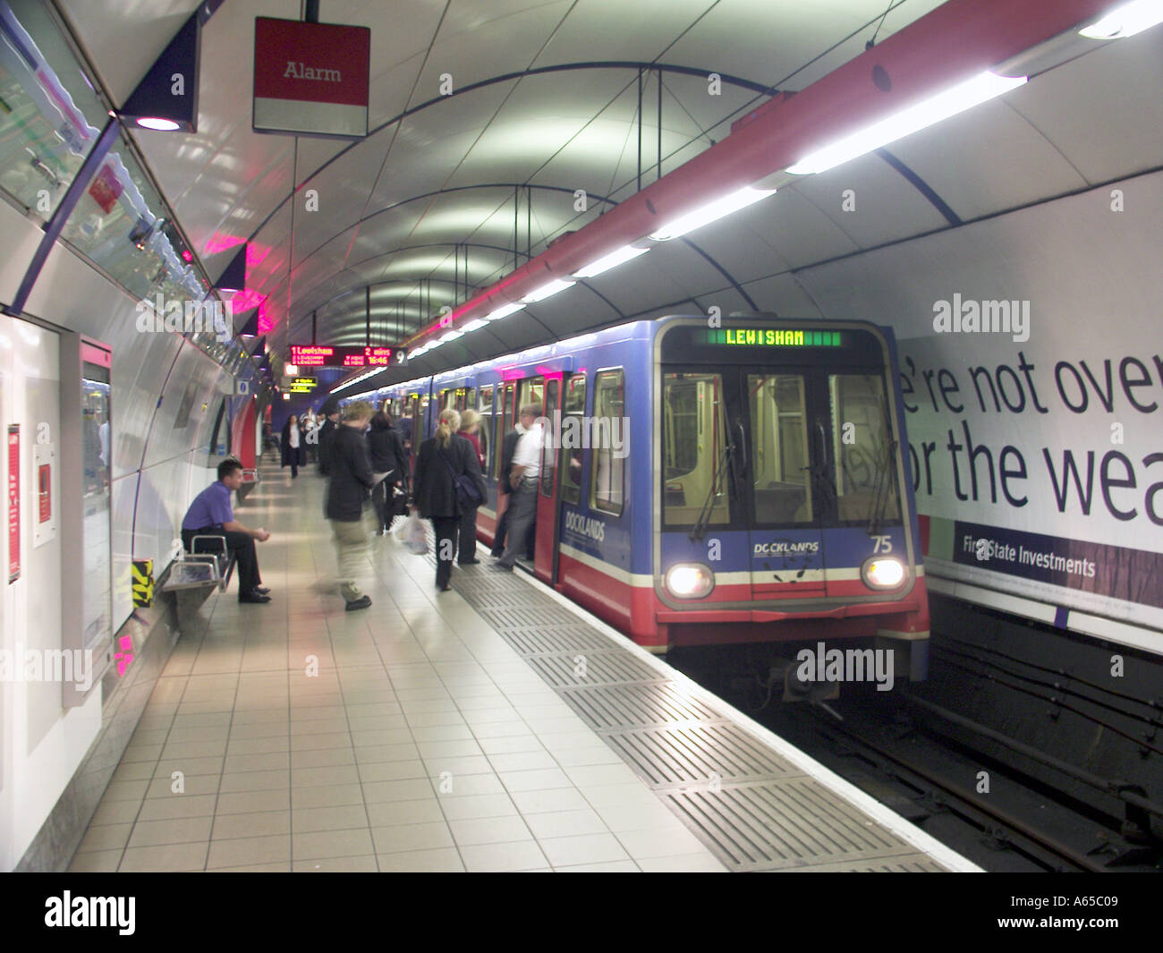 DLR London Docklands Light Railway train passengers boarding for Lewisham route at new below ground Bank station platform in City of London England UK Stock Photo