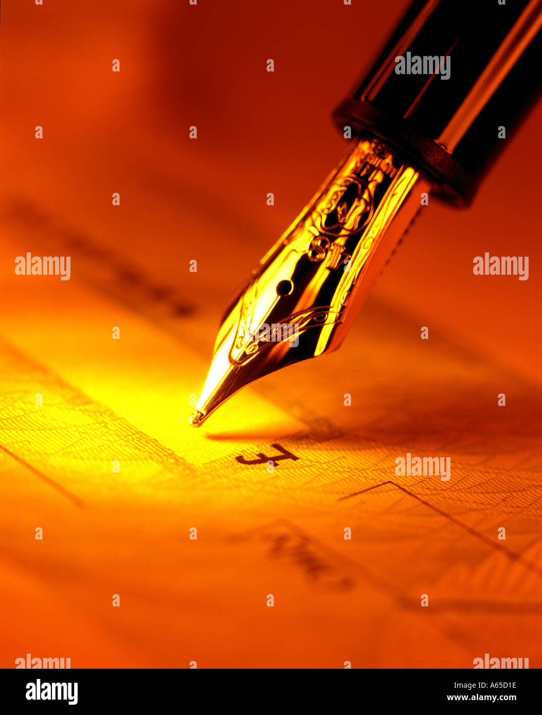 pen poised above UK GBP Sterling money cheque Stock Photo