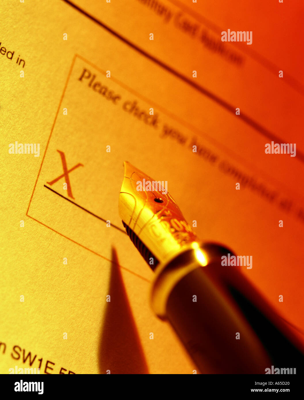 Nib pen poised above signature space on contract Stock Photo